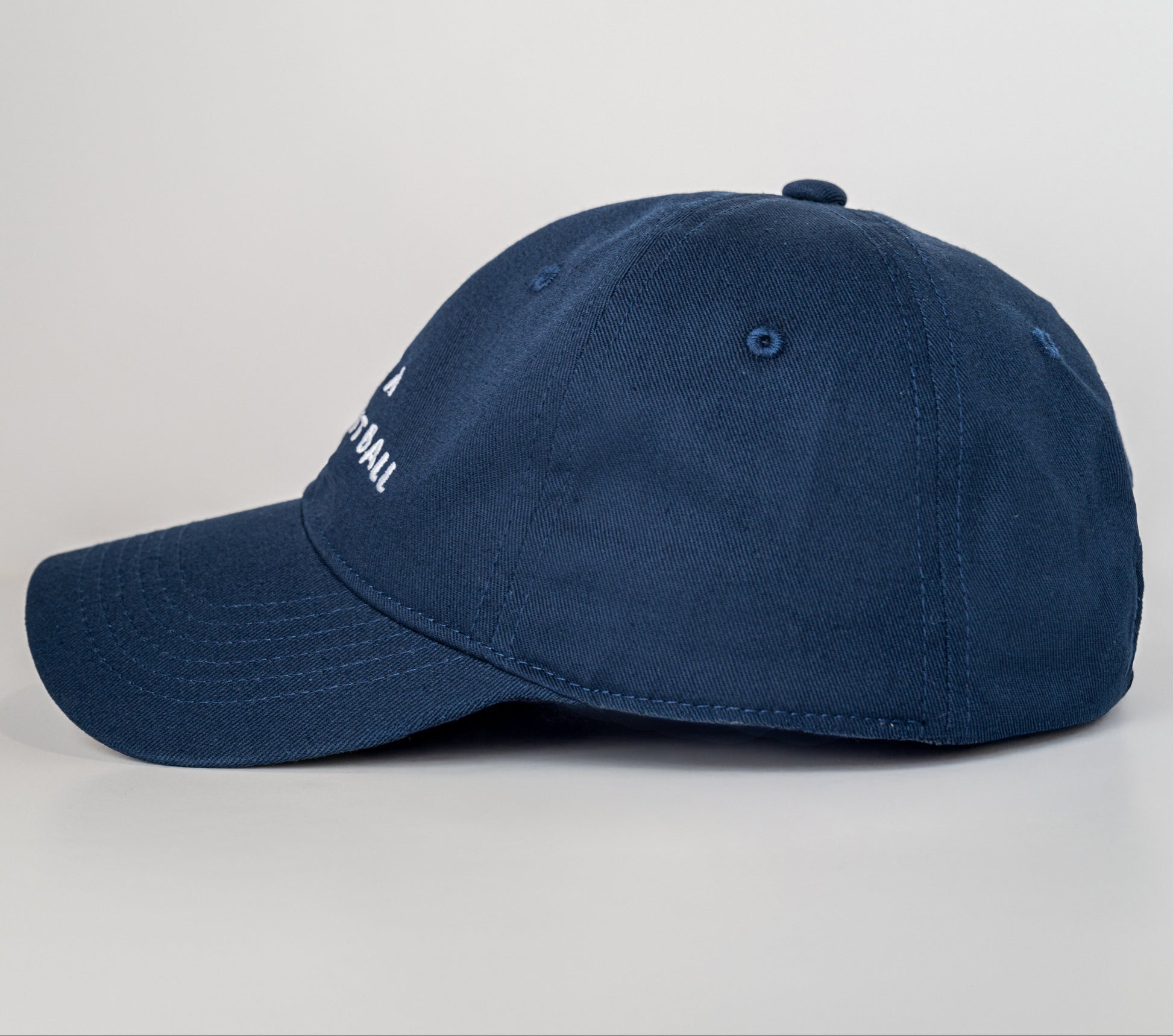 Navy blue cap with a brand logo on a light gray background
