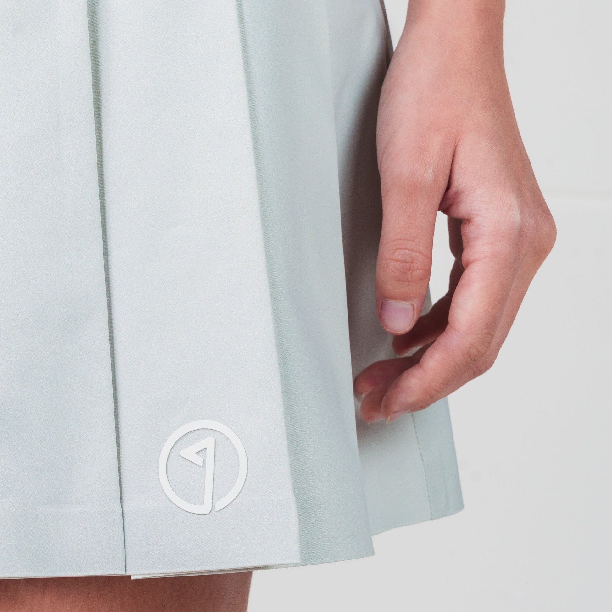 Light blue skirt with a logo on a white background