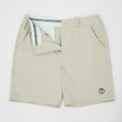 Beige shorts with a small logo on a white background