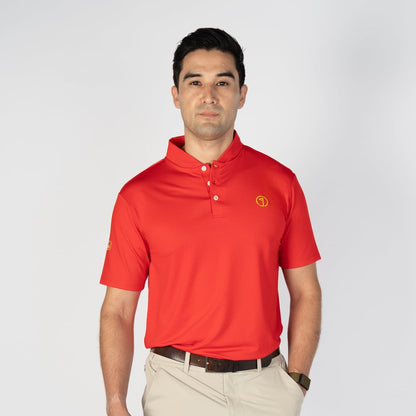 Man wearing a red polo shirt and beige shorts on a white background